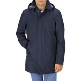 A man wearing a Navy Blue Nylon Laminar Car Coat by Herno with hood.