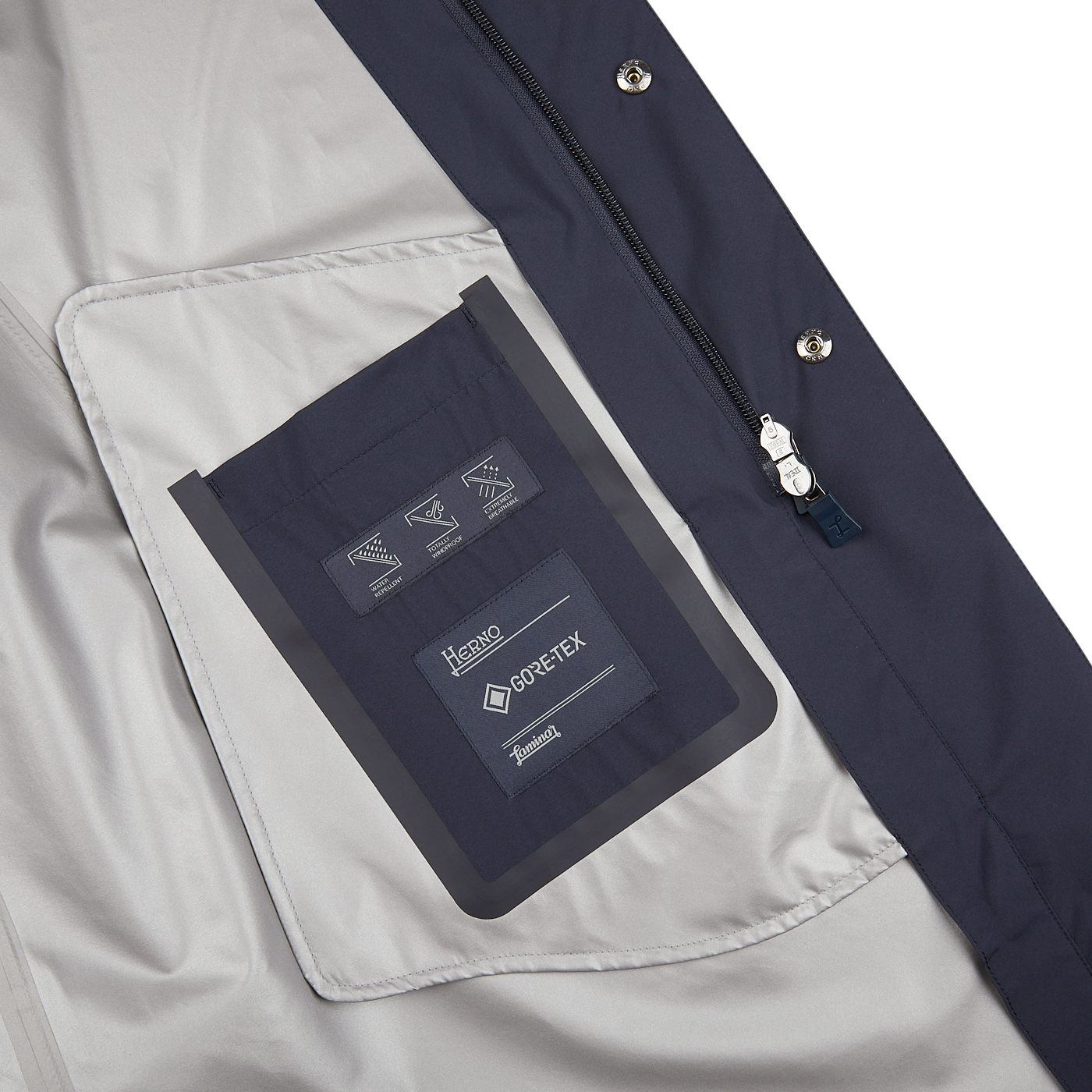 A Navy Blue Nylon Laminar Car Coat by Herno with a pocket and label on it.