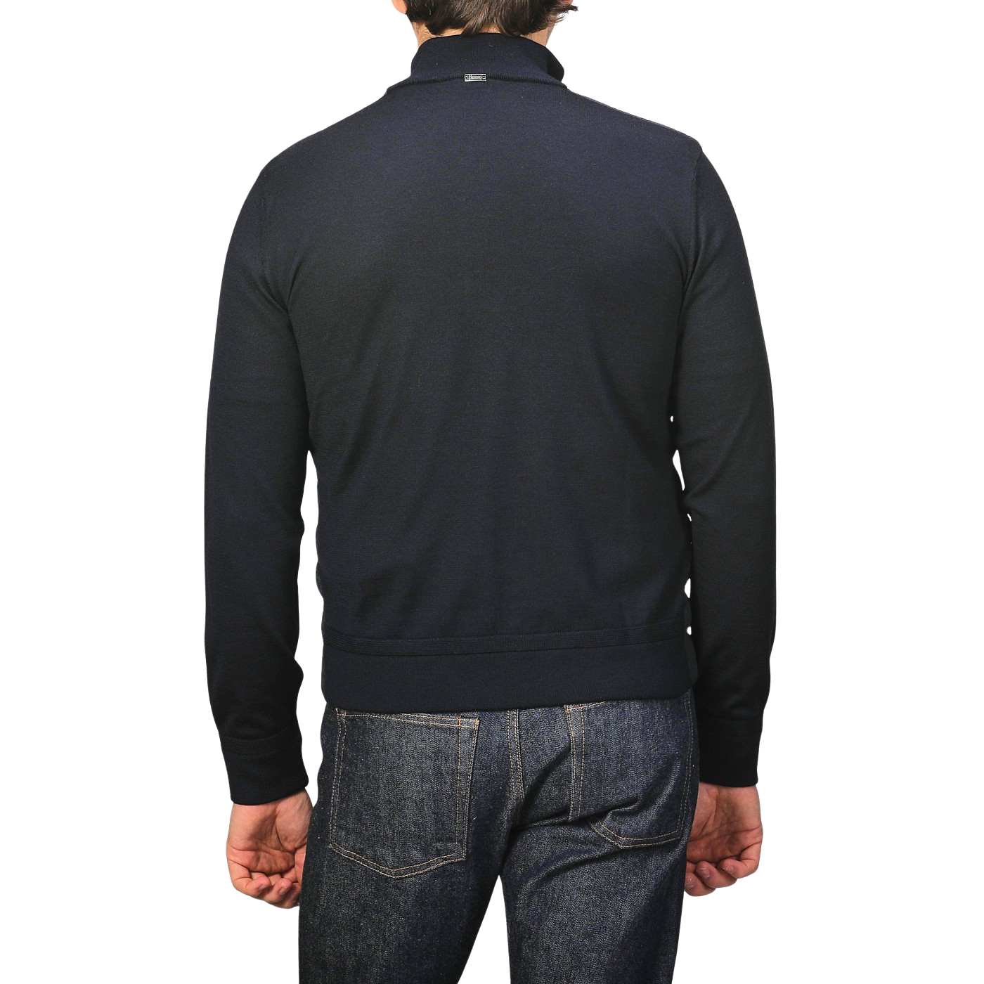 A person is seen from behind, wearing a Herno Navy Blue Wool Silk Nylon Padded Jacket and jeans against a plain background.