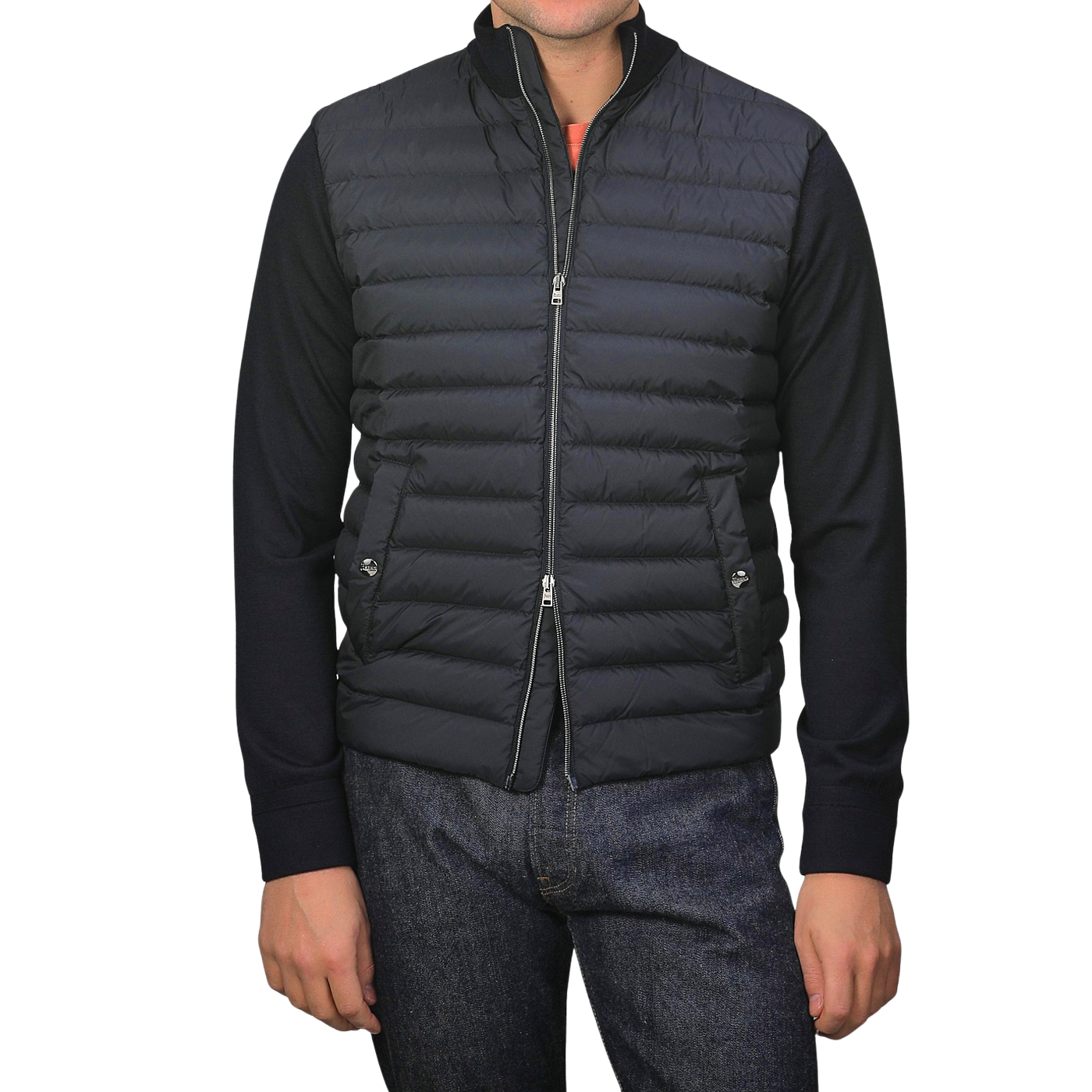 A person is wearing a Herno Navy Blue Wool Silk Nylon Padded Jacket over a long-sleeve sweater, paired with blue jeans, standing in front of a plain background.