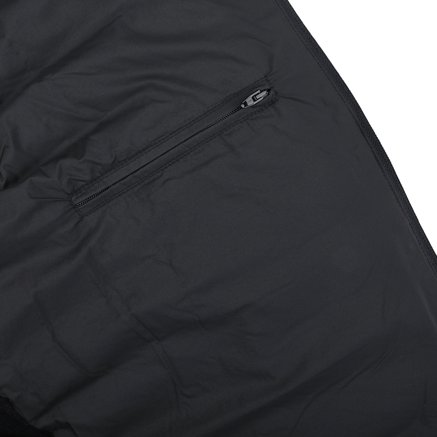 Close-up of a Navy Blue Wool Silk Nylon Padded Jacket by Herno, showcasing a zipper pocket on the sleek black fabric.