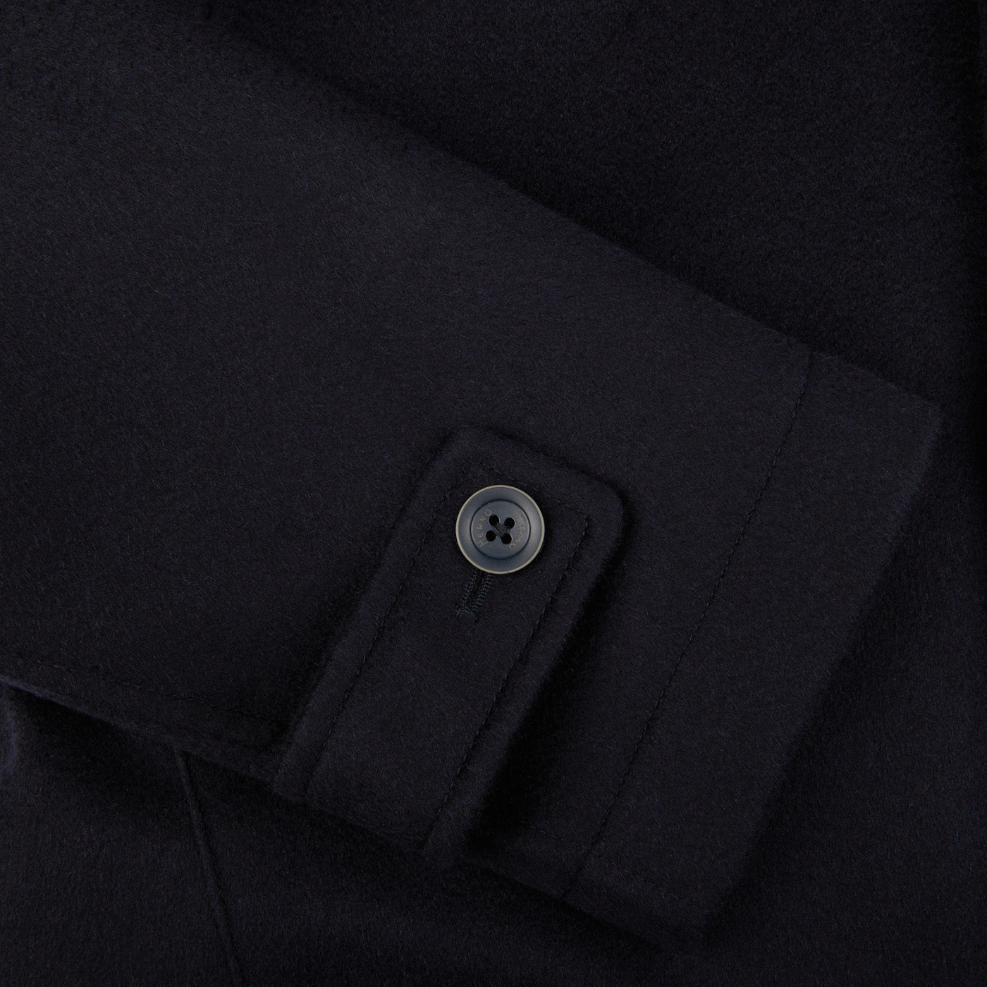 A close up of a Herno navy blue water repellent cashmere car coat with buttons.