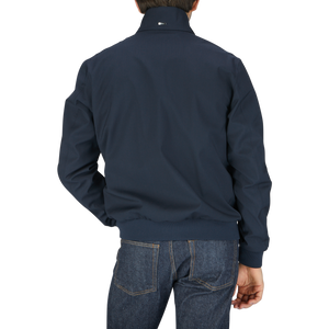 A man in a navy blue Herno Navy Wool Loro Piana Storm System Blouson jacket.