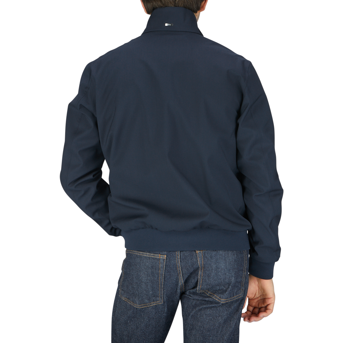 A man in a navy blue Herno Navy Wool Loro Piana Storm System Blouson jacket.