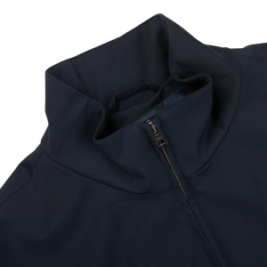 The back of a navy blue Herno Loro Piana Storm System Blouson jacket with a zipper.