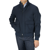 A man wearing a Navy Wool Loro Piana Storm System Blouson jacket and jeans.