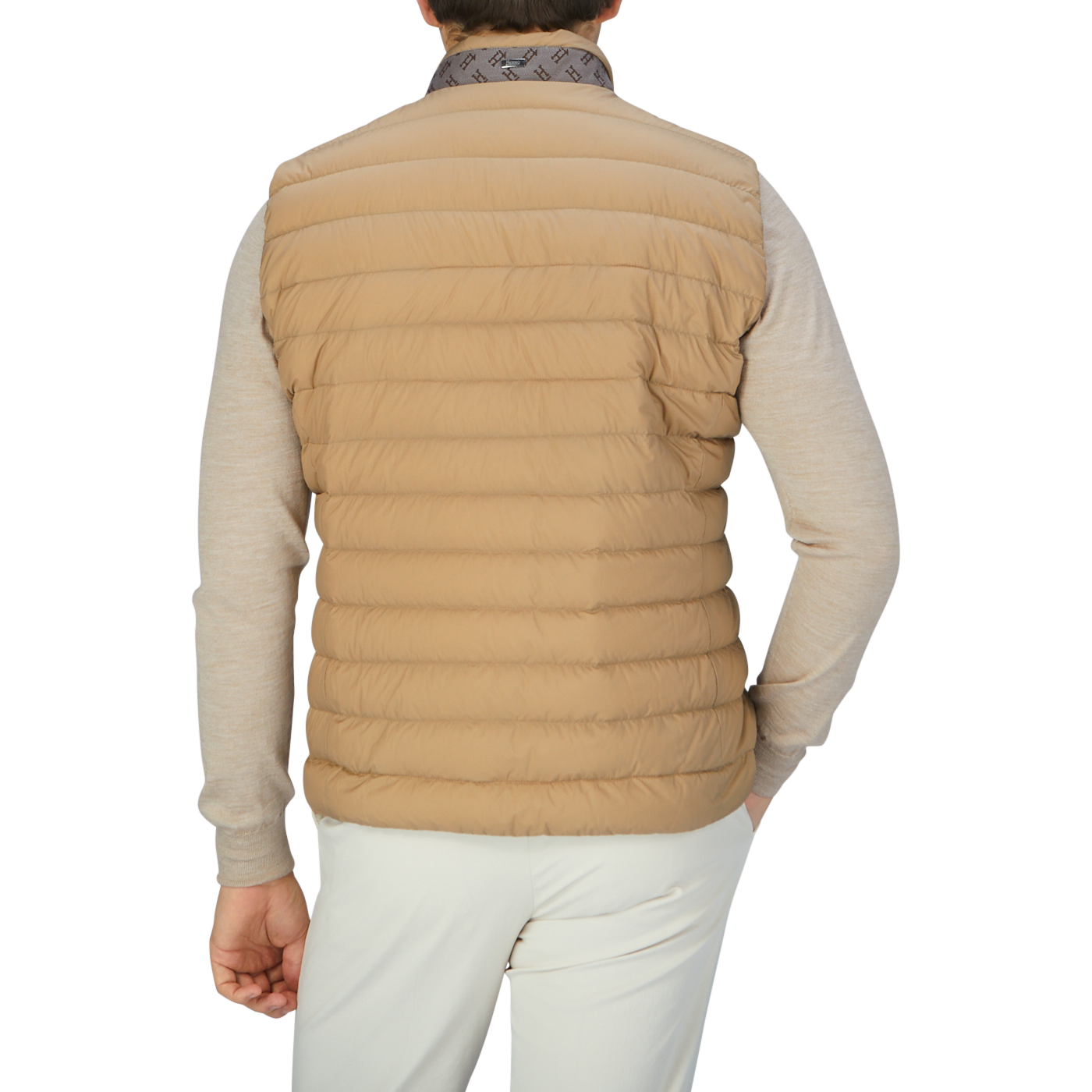 The back view of a man wearing a Herno Sand Beige Nylon Goose Down Quilted Gilet.