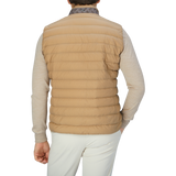 The back view of a man wearing a Herno Sand Beige Nylon Goose Down Quilted Gilet.