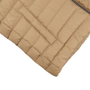 A sand beige Herno nylon goose down quilted gilet on a white surface.