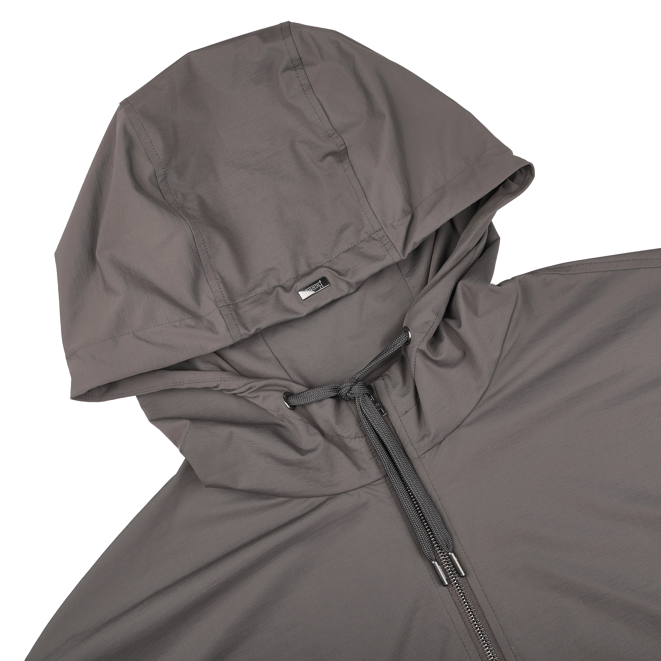 Close-up of a Taupe Beige Nylon Jersey Hood Jacket by Herno, made from lightweight nylon jersey, featuring a zipper and drawstring, shown on a black background.