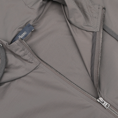 Close-up of the Herno Taupe Beige Nylon Jersey Hood Jacket displaying a slim fit, partially open zipper, and visible internal tag, crafted from lightweight nylon jersey.