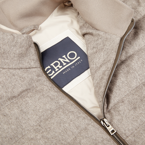 An image of a Herno Taupe Beige Silk Cashmere Water-Repellent Jacket, featuring a water-repellent label.