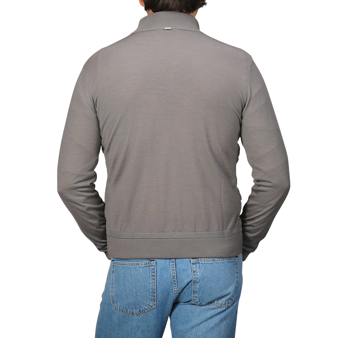 A person is wearing a Herno Taupe Beige Wool Silk Nylon Padded Jacket and blue jeans, facing away.