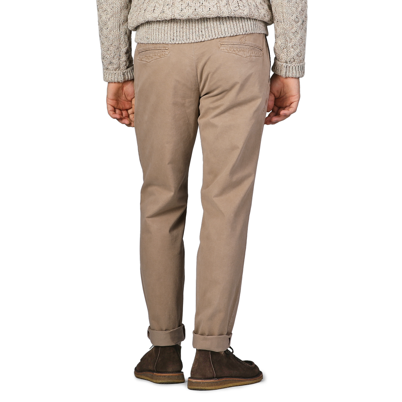 A person in Hiltl Beige Washed Cotton Gabardine Slim Chinos, a gray knit sweater, and brown shoes stands with their back to the camera.