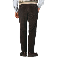 A person wearing Hiltl Brown Cotton Corduroy Regular Fit Chinos, a patterned sweater, and brown shoes is standing with their back facing the camera.