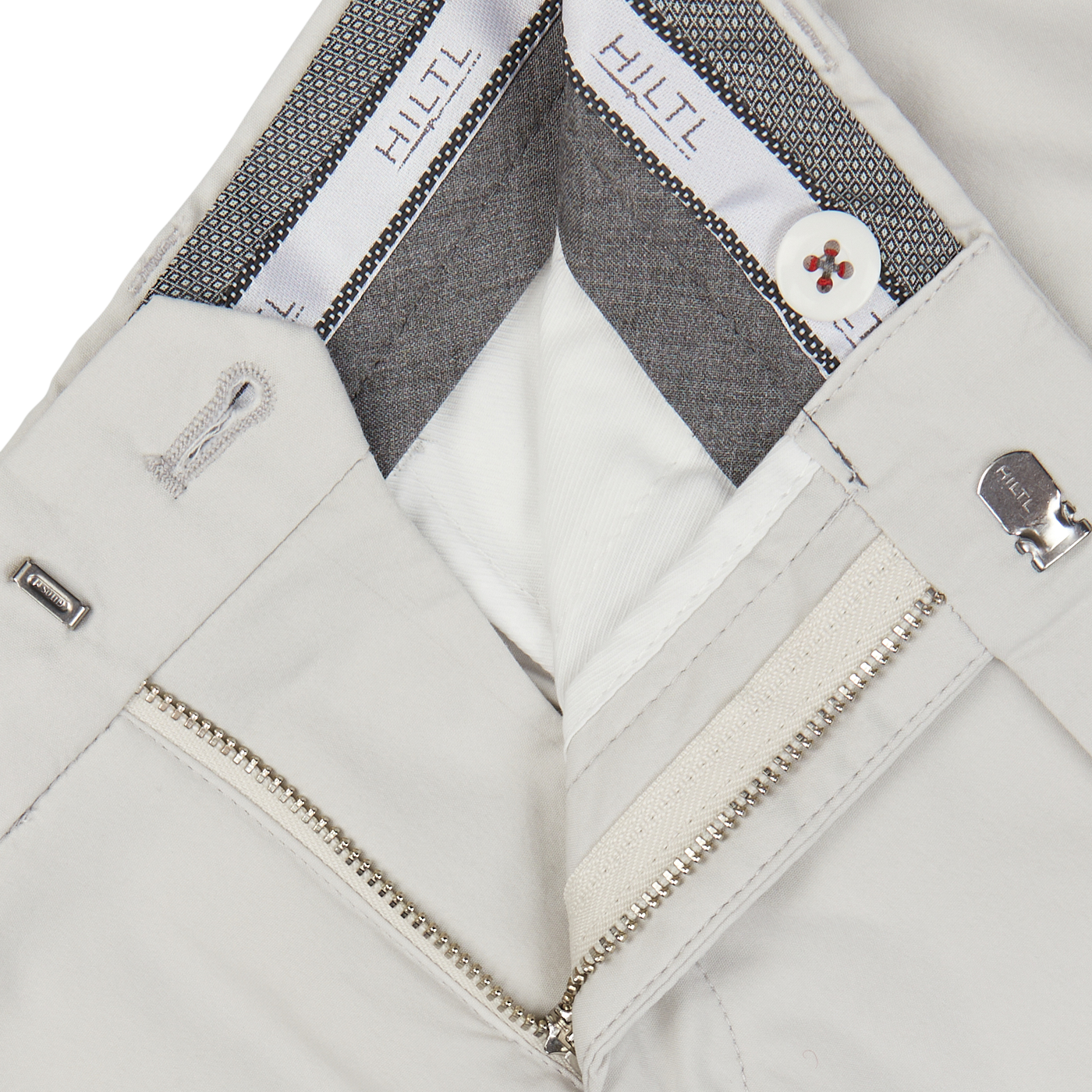 Close-up view of Cream Beige Cotton Nylon Slim Chinos by Hiltl with zipper details and a branded inner lining.