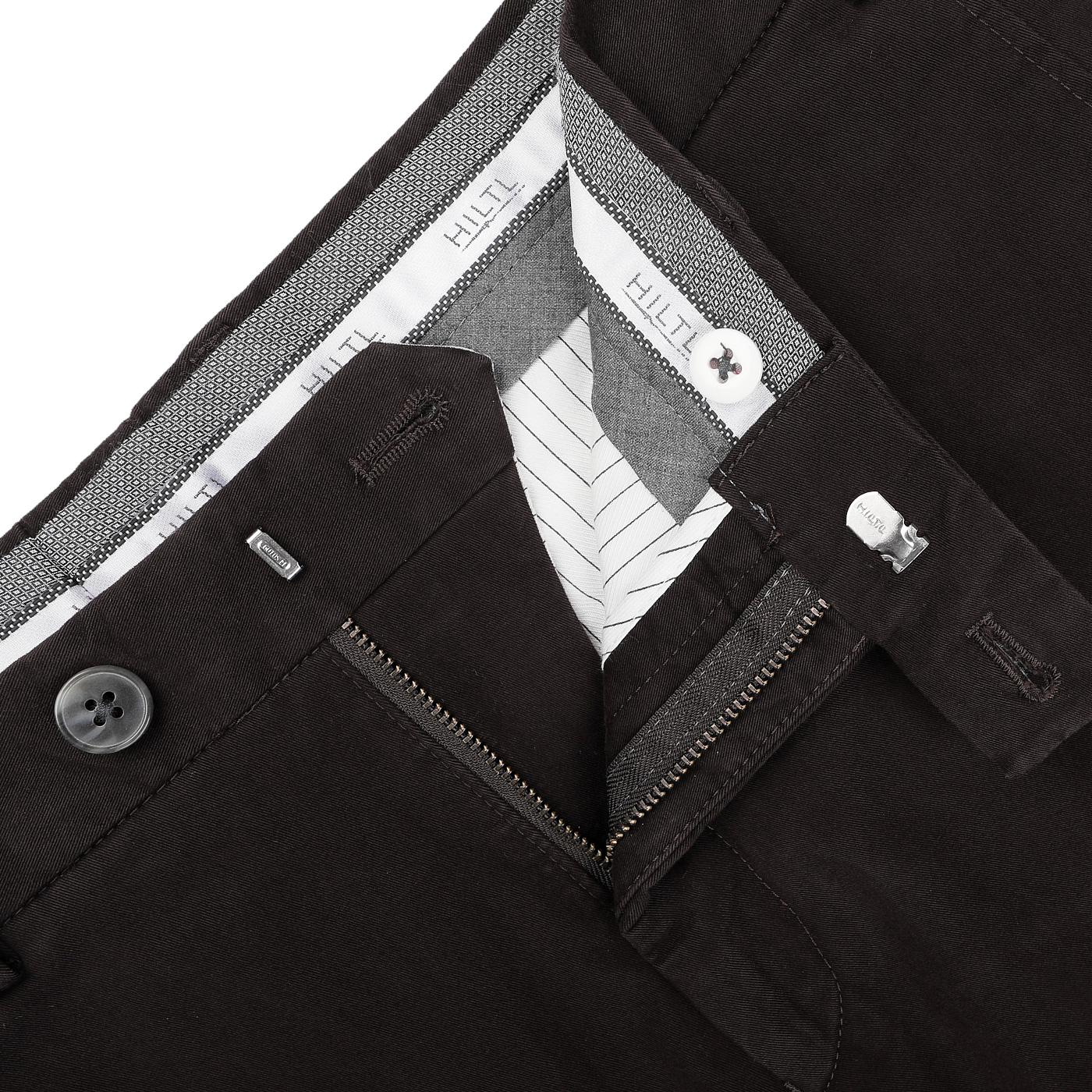 A close-up of the Dark Brown Cotton Stretch Regular Fit Chinos by Hiltl showcases a partially open zipper and button, revealing the inner lining and brand label.