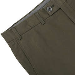 Close-up of Hiltl's Dark Green Cotton Stretch Regular Fit Chinos, showcasing a button and belt loops against a neutral background.