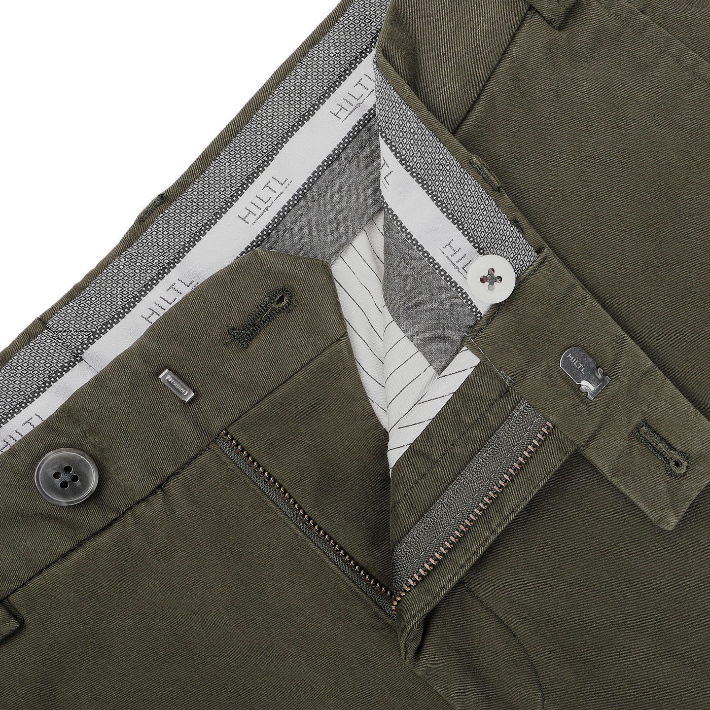 Close-up of Hiltl's Dark Green Cotton Stretch Regular Fit Chinos, featuring a zipper and button fastening. The inner waistband showcases a striped and branded lining, designed for added comfort with cotton twill.