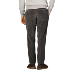 Someone is wearing Hiltl Grey Cotton Corduroy Regular Fit Chinos, a light sweater, and brown shoes, viewed from the back.