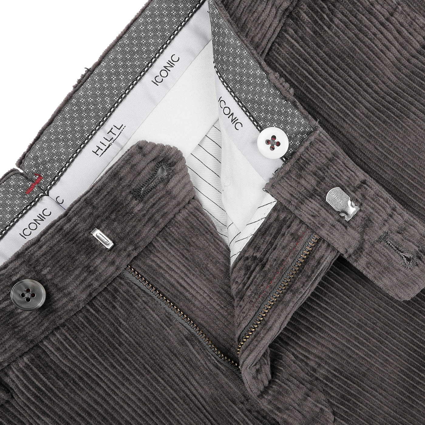 Close-up of a pair of Hiltl's Grey Cotton Corduroy Regular Fit Chinos with the front zipper partially open, showcasing the waistband with labels and patterned lining.