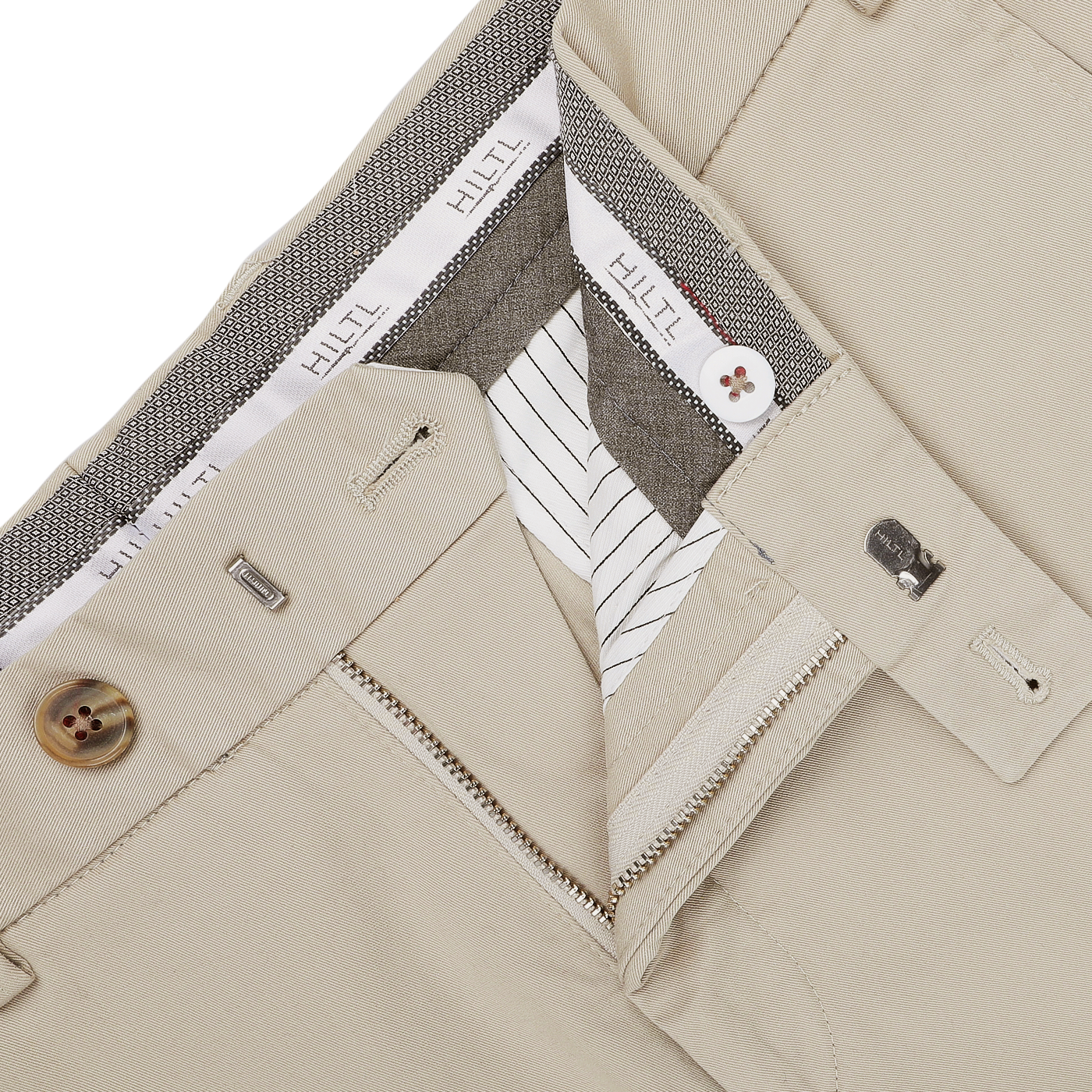 Close-up of khaki beige chinos with an unzipped fly revealing the interior lining; features include belt loops, buttons, and a waistband showcasing the "Hiltl" brand label. These regular fit pants are made from pure cotton twill for both comfort and style.