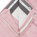 Close-up of a Light Pink Washed Linen Regular Fit Chinos from Hiltl with a zipper, featuring striped lining and designer labels.