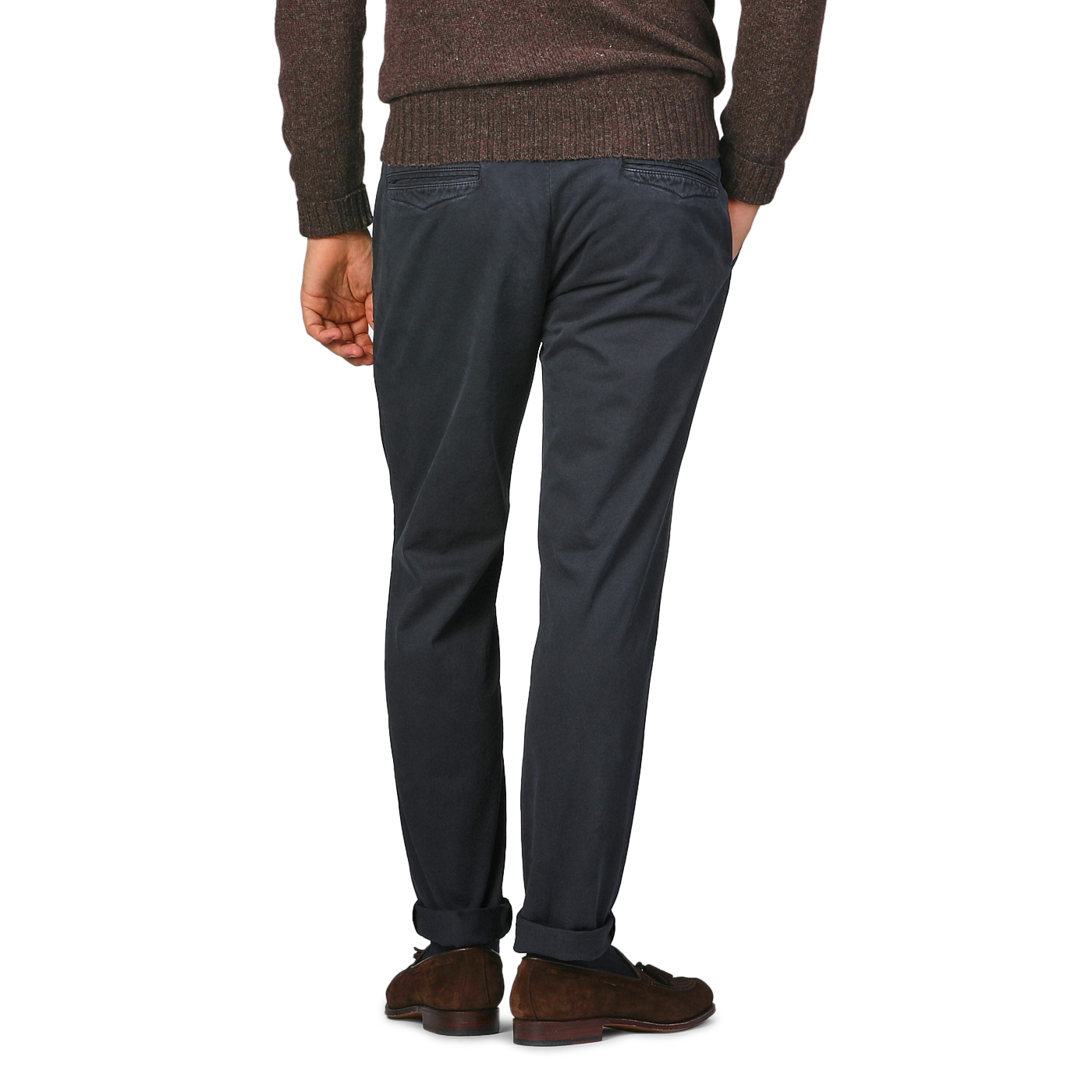 A person in a brown sweater and Hiltl Navy Washed Cotton Gabardine Slim Chinos, seen from behind, stands on a gray background.