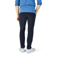 The man is wearing Incotex Blue Micro Cotton Corduroy High Comfort Chinos and a blue shirt, with a slim fit.