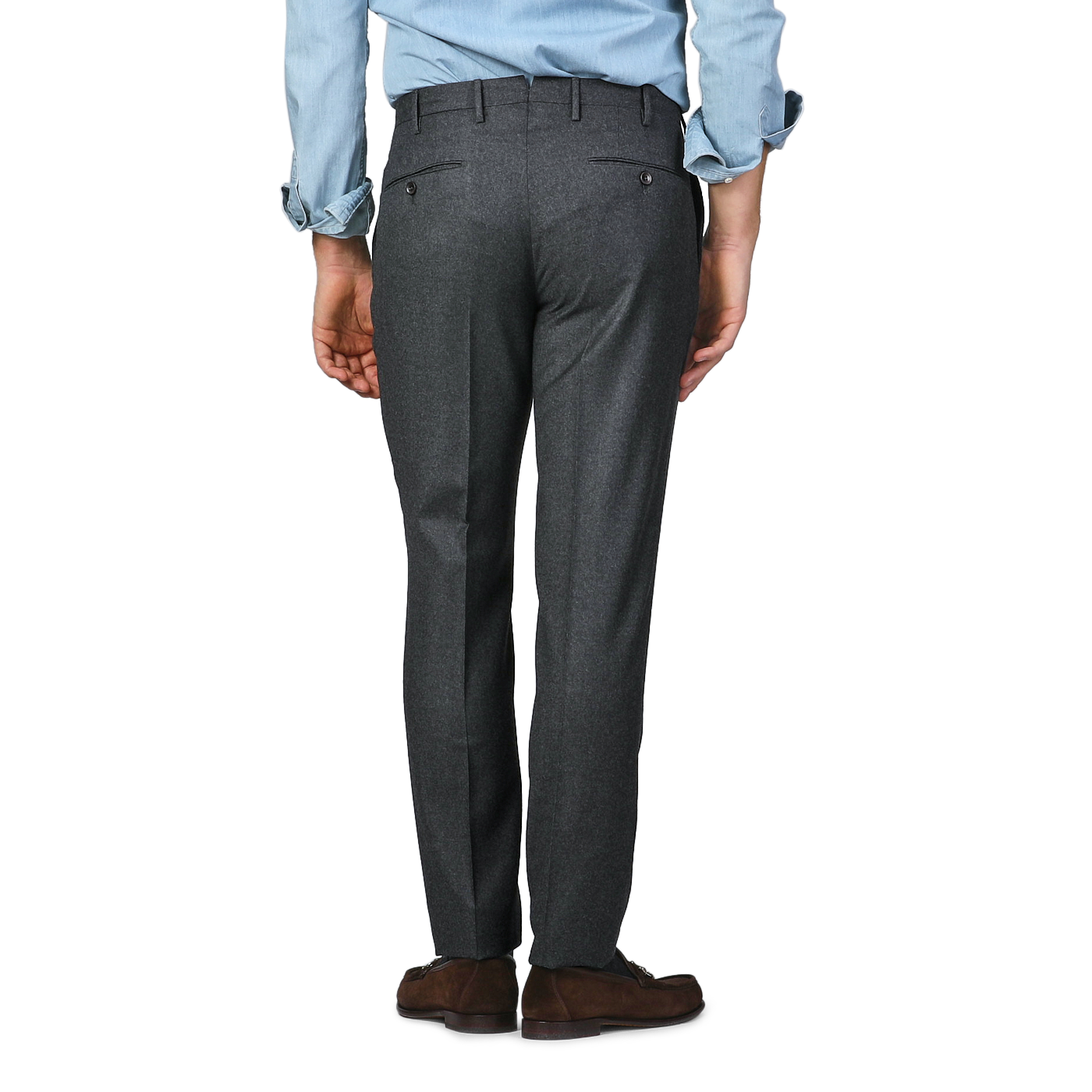 An individual wearing a blue shirt and Incotex Charcoal Grey Wool Flannel Slim Trousers is seen from behind, standing against a light gray backdrop.