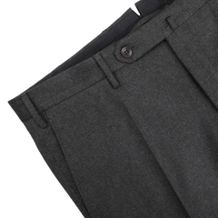 Close-up of Incotex's Charcoal Grey Wool Flannel Slim Trousers, showcasing button details and belt loops against a light backdrop.