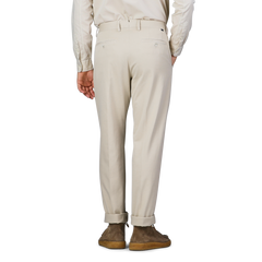 An individual wearing Incotex's Cream Beige Cotton Stretch Model 8 Chinos paired with brown shoes, seen from behind.