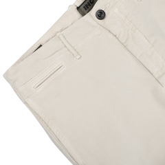 Close-up of Cream Beige Cotton Moleskin Slacks Chinos by Incotex, highlighting the waistband, button, and belt loop details against a neutral background.