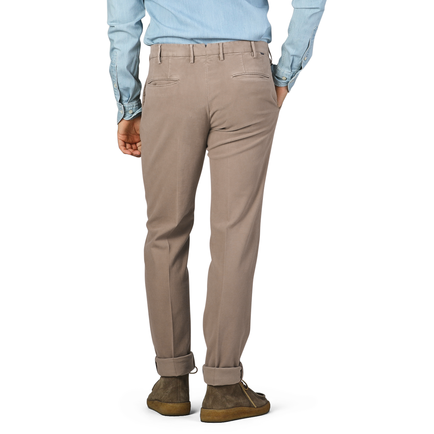 A person in dark beige Incotex cotton moleskin Model 30 chinos and a light blue shirt, viewed from behind.