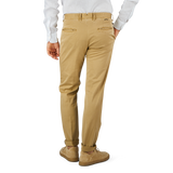 A person in a white shirt and Dark Beige Cotton Stretch Slacks Chinos is standing with their back to the camera against a plain background. They are wearing beige shoes by Incotex.