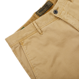 Close-up of Incotex Dark Beige Cotton Stretch Slacks Chinos with front pocket detailing and a visible label inside the waistband. The cotton twill chinos feature a button closure, belt loops, and a slim fit tapered leg.