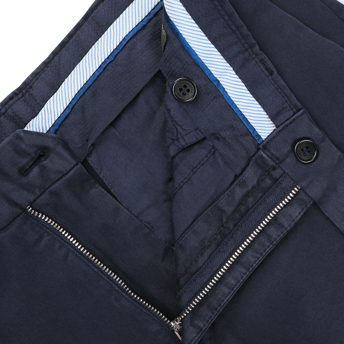 Close-up of the inside of Incotex's Dark Blue Cotton Stretch Model 30 Chinos, featuring a zipper, two buttons, and a blue striped fabric lining the waistband.