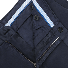 Close-up of the inside of Incotex's Dark Blue Cotton Stretch Model 30 Chinos, featuring a zipper, two buttons, and a blue striped fabric lining the waistband.