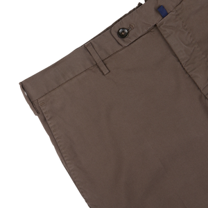 Close-up of Incotex dark brown cotton stretch regular chinos with a button closure on a white background.