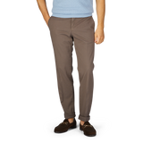 A person wearing royal Incotex cotton stretch regular chinos and brown shoes stands against a white background.