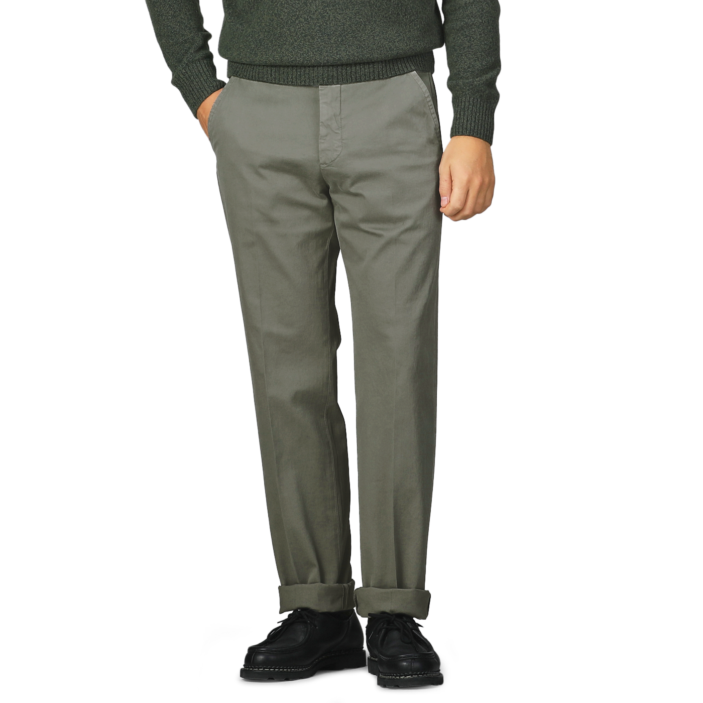 A person dressed in Incotex's Dark Green Cotton Stretch Model 8 Chinos, regular fit gray cotton twill chinos, and black shoes stands with hands in pockets on a plain background.