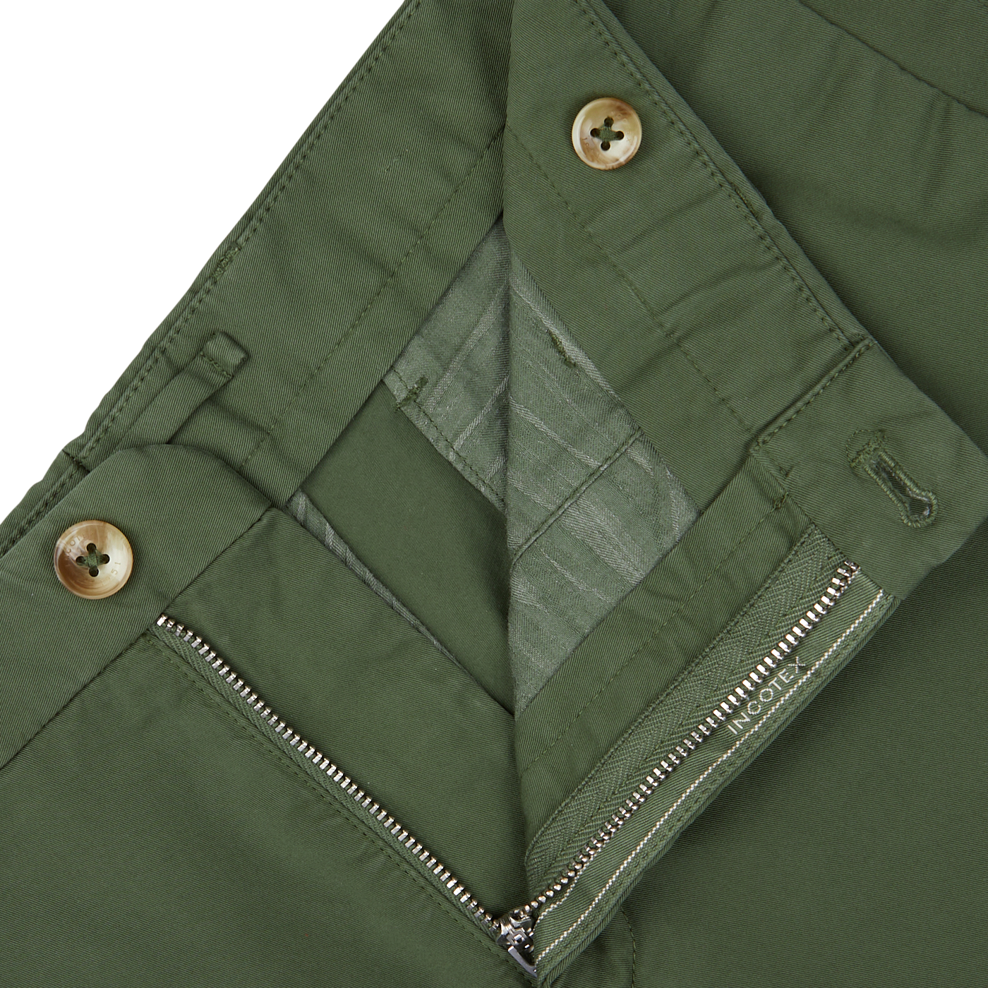 Close-up of a grass green jacket with zipper and button fastenings, paired with high-comfort Incotex shorts.