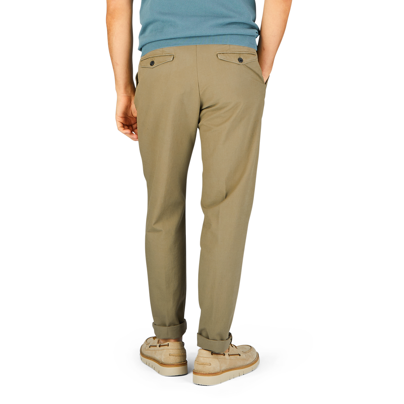A person standing in Incotex Grass Green Cotton Stretch Pleated Chinos and beige sneakers against a blue background.