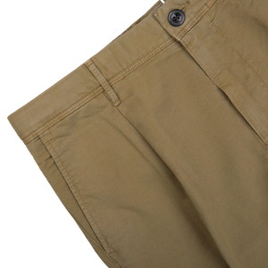 Close-up of a Grass Green Cotton Stretch Pleated Chinos by Incotex showing the waistband, button, and stitching on a white background.