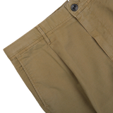 Close-up of a Grass Green Cotton Stretch Pleated Chinos by Incotex showing the waistband, button, and stitching on a white background.