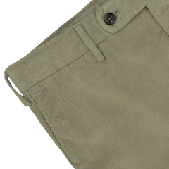 Close-up of Incotex's Green Cotton Corduroy High Comfort Chinos featuring a waistband with belt loops, a button, and a zipper fly, designed in a slim fit for added style.