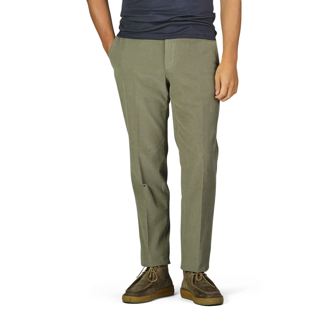 A person wearing Incotex Green Cotton Corduroy High Comfort Chinos, a dark shirt, and brown shoes stands with hands in pockets.