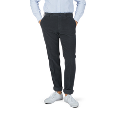 A man in Grey Micro Cotton Corduroy High Comfort Chinos by Incotex is posing.