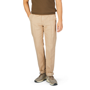 Man wearing Light Beige Chinolino Straight Fit Incotex trousers and light brown shoes standing against a white background.