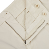 A pair of Incotex Light Beige Cotton Stretch Regular Chinos, featuring zippers on the side for a regular fit.